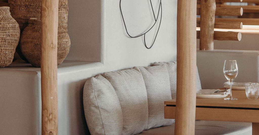 Minimalist interior seating area with smooth Terrazzo GraniTech wall, showcasing a high-quality type of interior plaster finish in a modern dining space