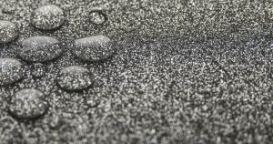 Close-up of resin bound gravel driveway with water droplets highlighting permeable surface and excellent drainage performance
