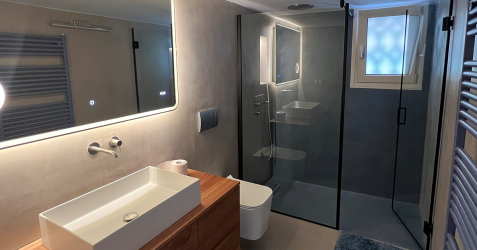 Luxury bathroom with TERRAZZO GraniTech seamless plaster finish on bathroom walls and shower walls, showing modern alternative to traditional Moroccan tadelakt with superior durability and easy maintenance