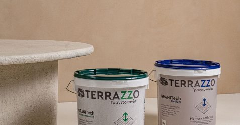 “Terrazzo GraniTech finish on wall and surface next to product buckets – a modern alternative in the gypsum plastering vs cement plastering debate.
