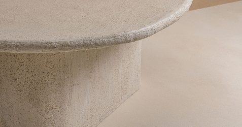 Microtopping flooring installation showing seamless concrete overlay with smooth texture on curved architectural feature