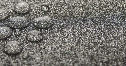 Close-up of resin bound gravel driveway with water droplets highlighting permeable surface and excellent drainage performance